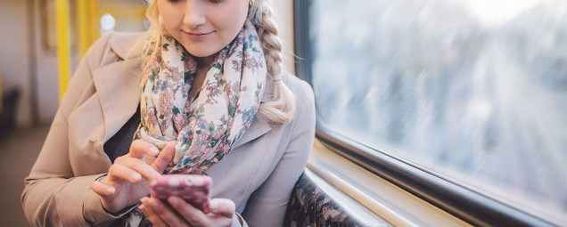 Woman using smart phone in subway